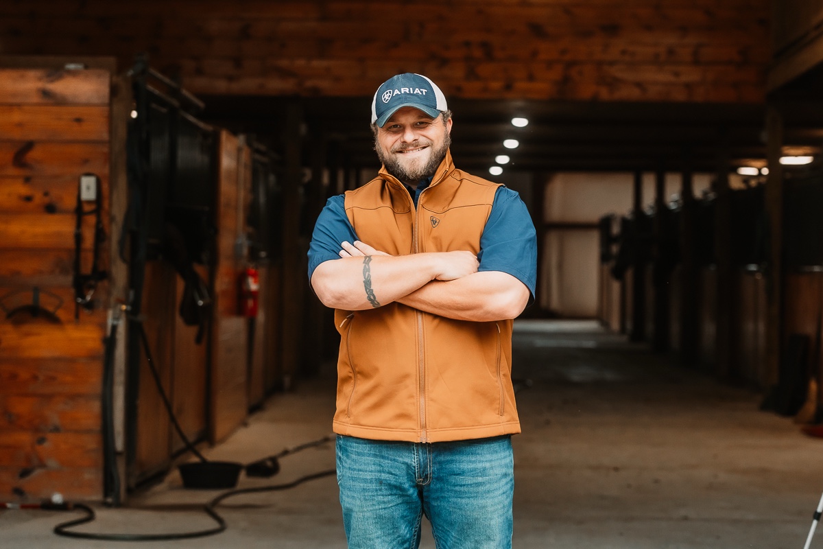 Chris Leopardi standing in a ranch stable